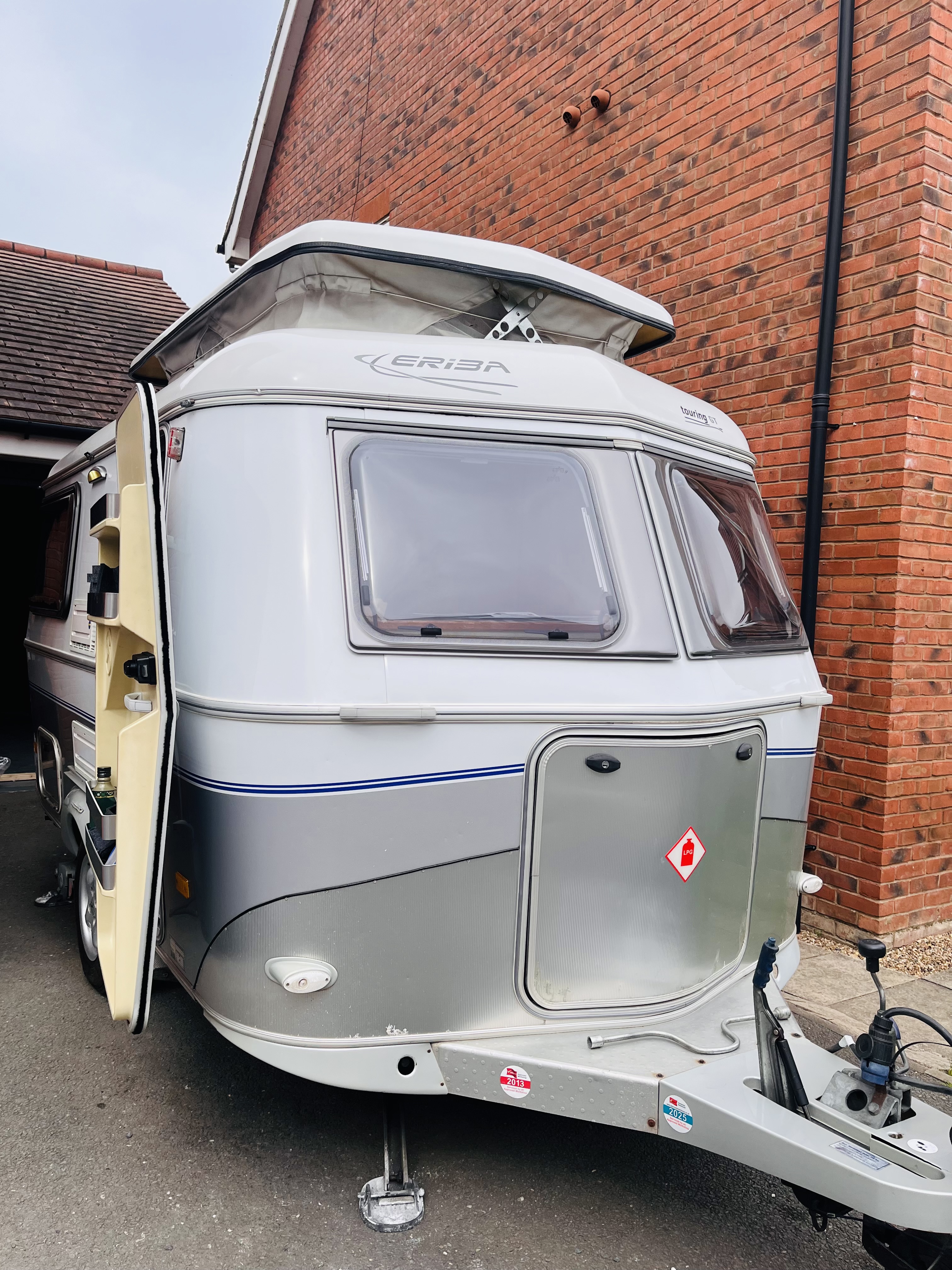 Plum parked near a brick wall